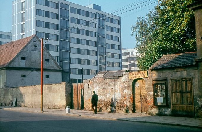 Jako Damoklův meč se nad krámkem soustružníka Maňhala zdvihají paneláky architekta Böhma. Stará a nová Lidická třída, výmluvné svědectví o přerodu města. Říjen 1964.