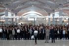 Zaměstnanci nového letiště se shromáždili před odletem prvního letadla po slavnostním otevření.