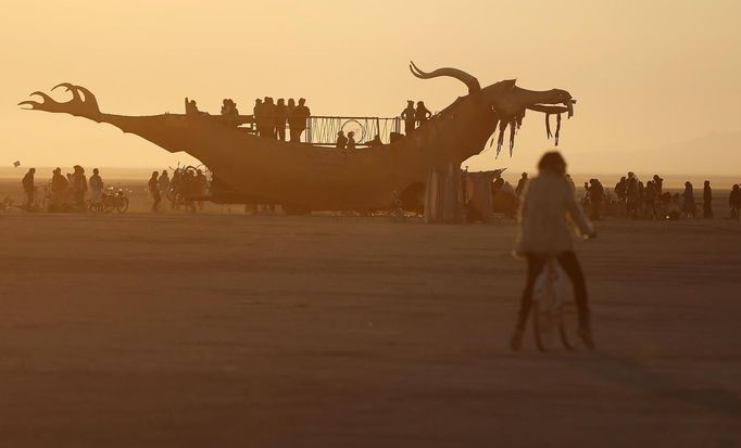 Participants watch the sunrise from an art car during the Burning Man 2012 "Fertility 2.0" arts and music festival in the Black Rock Desert of Nevada, August 29, 2012. More than 60,000 people from all over the world have gathered at the sold out festival, which is celebrating its 26th year, to spend a week in the remote desert cut off from much of the outside world to experience art, music and the unique community that develops.