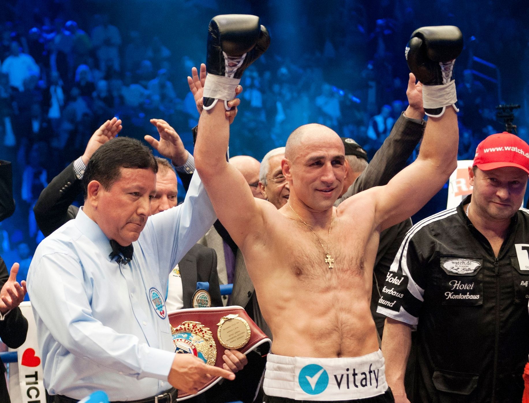 German WBO super-middleweight boxer, Arthur Abraham (C), celebrates victory against his challenger Britain's Paul Smith, after their title fight in Berlin