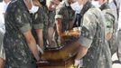 Army soldiers carry a coffin containing the body of a victim of the fire at Boate Kiss nightclub in the southern city of Santa Maria, 187 miles (301 km) west of the state capital of Porto Alegre, January 27, 2013. A fire in a nightclub killed at least 245 people in southern Brazil on Sunday when a band's pyrotechnics show set the building ablaze and fleeing patrons were unable to find the emergency exits in the ensuing panic, officials said. The blaze in the southern city of Santa Maria was started when a band member or someone from its production team ignited a flare, which then set fire to the ceiling, said Luiza Sousa, a civil police official. The fire spread "in seconds," she said. An estimated 500 people were in the Boate Kiss nightclub when the fire broke out early on Sunday, and many were unable to find the exits as dark smoke quickly filled the room. At least one exit was locked, trapping hundreds inside to die, many from asphyxiation as they inhaled smoke, police said. REUTERS/Edison Vara (BRAZIL - Tags: DISASTER MILITARY) Published: Led. 27, 2013, 7:57 odp.