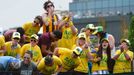 Fans of Samantha Stosur of Australia cheer on court 18 at the start of her women's singles tennis match against Olga Puchkova of Russia at the Wimbledon Tennis Championsh