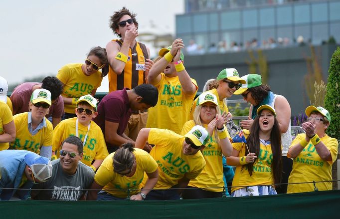 Fans of Samantha Stosur of Australia cheer on court 18 at the start of her women's singles tennis match against Olga Puchkova of Russia at the Wimbledon Tennis Championsh