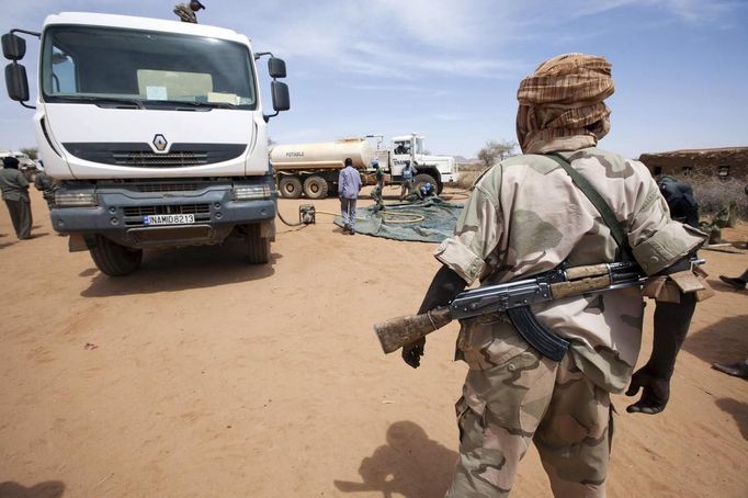 A member of the rebel movement Sudan Liberation Army (SLA) - Abdul Wahid, escorts the delivery of 30,000 litres of water in Forog