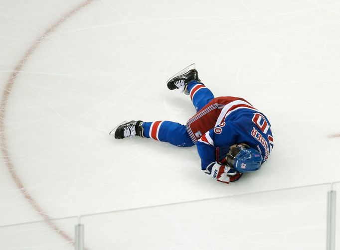 New York Rangers left wing Chris Kreider lies on the ice after a collision while playing the Boston Bruins in the third period of Game 3 of their NHL Eastern Conference s