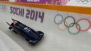 Great Britain's two-men bobsleigh pilot Lamin Deen speeds down the track during an unofficial men bobsleigh progressive training at the Sanki sliding center in Rosa Khuto