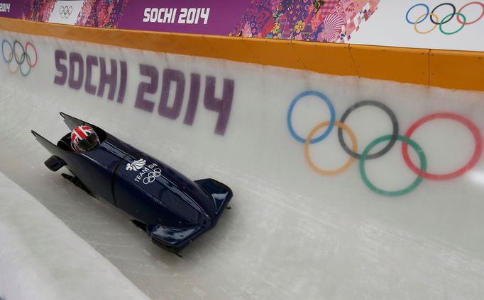 Great Britain's two-men bobsleigh pilot Lamin Deen speeds down the track during an unofficial men bobsleigh progressive training at the Sanki sliding center in Rosa Khuto