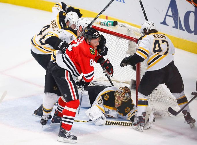 Boston Bruins goalie Tuukka Rask lies on the ice after the puck passed the goal line as teammates Torey Krug (R), Dennis Seidenberg and David Krejci (L) attempt to clear