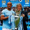 Manchester City's Kompany and manager Manuel Pellegrini pose for pictures with the English Premier League trophy following their soccer match against West Ham United at the Etihad Stadium in Mancheste
