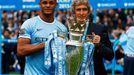 Manchester City's Kompany and manager Manuel Pellegrini pose for pictures with the English Premier League trophy following their soccer match against West Ham United at t