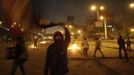 An anti-Mursi protester waves a national flag during clashes with members of the Muslim Brotherhood and ousted Egyptian President Mohamed Mursi supporters, along a road at The Ramsis square which leads to Tahrir Square, during a celebration marking Egypt's 1973 war with Israel, in Cairo October 6, 2013. At least 33 people were killed during protests in Egypt on Sunday, the interior ministry said, as the crisis since the army seized power three months ago showed no sign of abating.