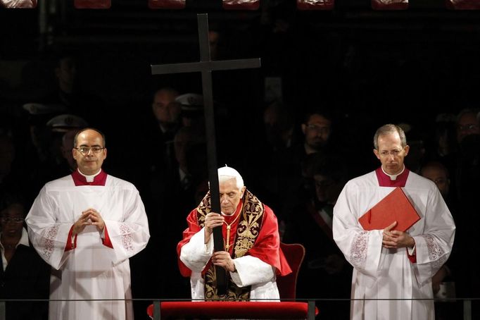 Papež Benedikt XVI. drží kříž při křížové cestě před římským Koloseem.