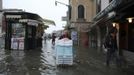 A worker transports materials during a period of seasonal high water in Venice October 27, 2012. The water level in the canal city rose to 127 cm (50 inches) above the normal level, according to the monitoring institute. REUTERS/Manuel Silvestri (ITALY - Tags: ENVIRONMENT SOCIETY TRAVEL) Published: Říj. 27, 2012, 12:15 odp.