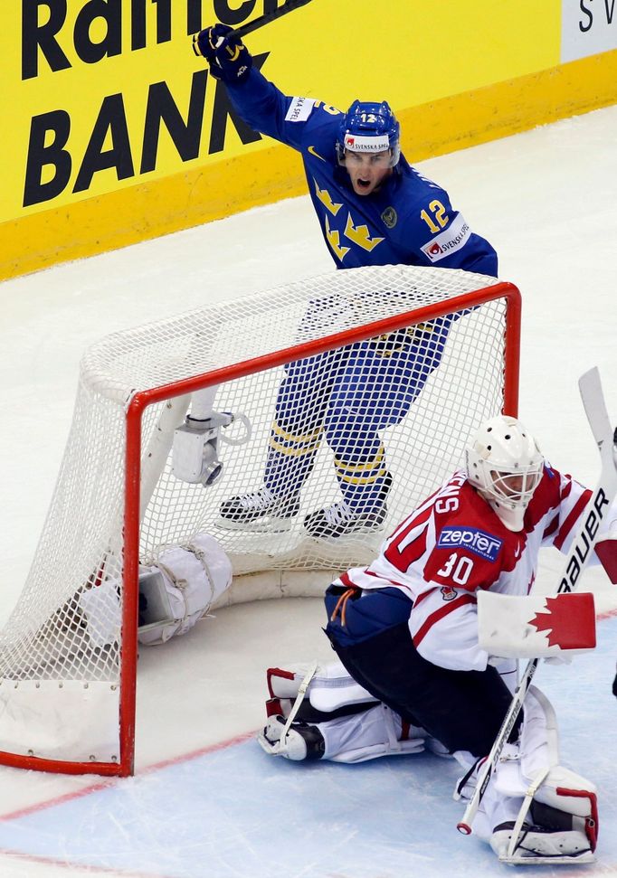 Sweden's Joakim Lindstrom celebrates his goal as Canada's goalie Ben Scrivens (R) reacts during the first period of their men's ice hockey World Championship Group A game