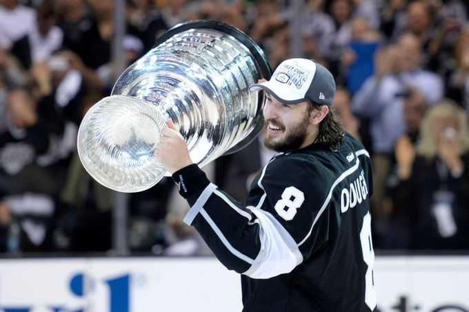 Jun 13, 2014; Los Angeles, CA, USA; Los Angeles Kings defenseman Drew Doughty (8) skates around the rink with the Stanley Cup after defeating the New York Rangers game fi