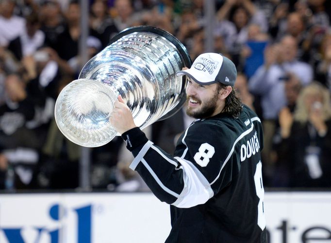 Jun 13, 2014; Los Angeles, CA, USA; Los Angeles Kings defenseman Drew Doughty (8) skates around the rink with the Stanley Cup after defeating the New York Rangers game fi