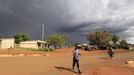 A man walks before a rainstorm in Kogelo village, the ancestral home of U.S. President Barack Obama in Nyangoma Kogelo, 430 km (367 miles) west of Kenya's capital Nairobi, November 5, 2012. Four years ago, Kogelo, and Africa in general, celebrated with noisy gusto when Obama, whose father came from the scattered hamlet of tin-roofed homes, became the first African-American to be elected president of the United States. Looking across the Atlantic to the November 6 presidential election, the continent is cooler now towards the "son of Africa" who is seeking a second term. There are questions too whether his Republican rival, Mitt Romney, will have more to offer to sub-Saharan Africa if he wins the White House. To match Analysis AFRICA-USA/ELECTION REUTERS/Thomas Mukoya (KENYA - Tags: SOCIETY POLITICS ELECTIONS USA PRESIDENTIAL ELECTION) Published: Lis. 5, 2012, 3:39 odp.