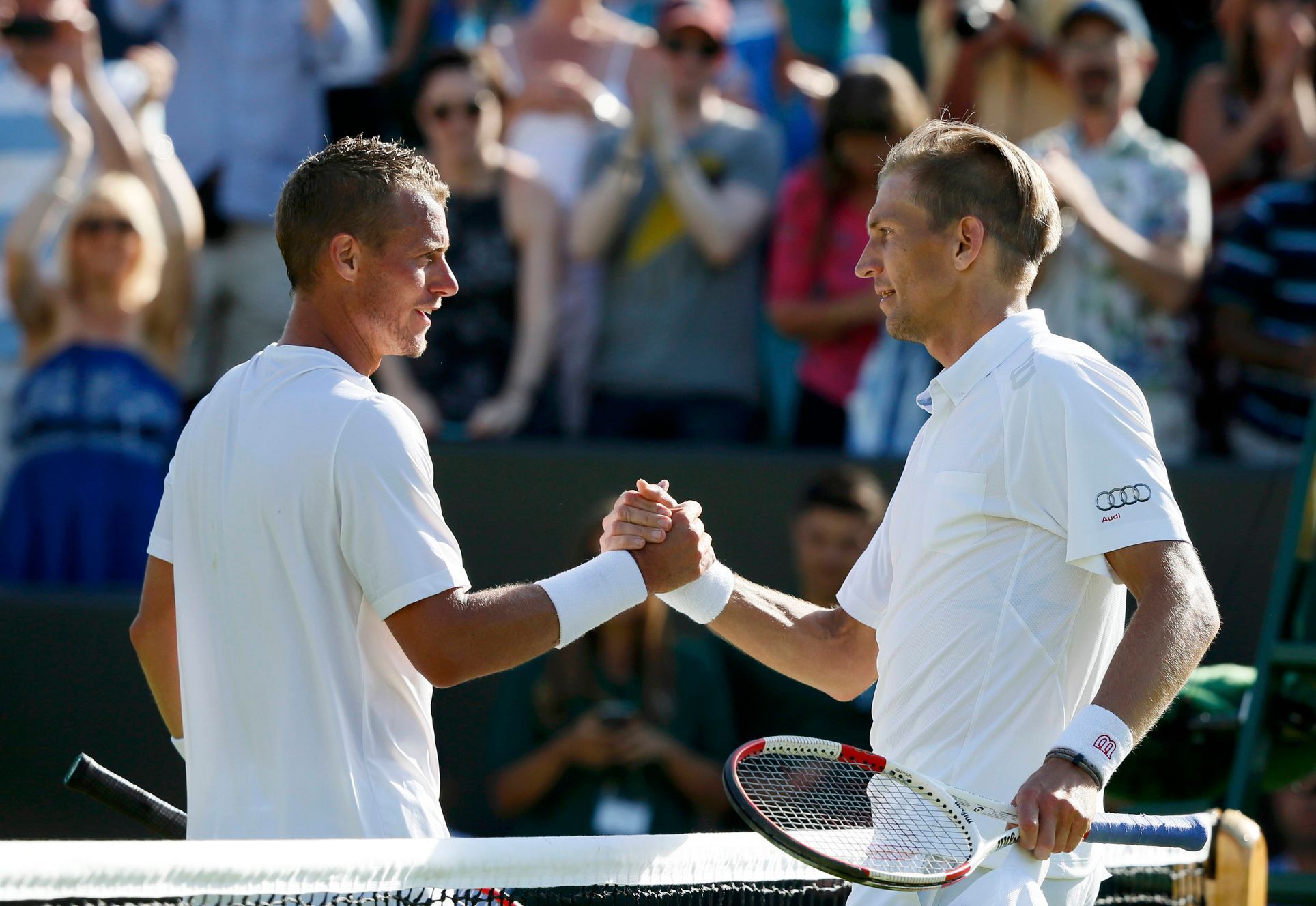Jarkko Nieminen of Finland shakes hands with Lleyton Hewitt of Australia after winning their match at the Wimbledon Tennis Championships in London