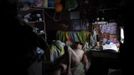 Xiao Cao, a 57-year-old gay man, lays down on his bed in his eight-square-metre apartment in Shanghai April 22, 2012. China's gay community has long been on the edges of society but it is gradually becoming more accepted. Cao, who is an unemployed drag queen, is one whose life lifts the curtain on a less romanticised view of Chinese homosexuals. Living in an eight-square-metre apartment behind a public toilet and with a monthly income of 500 yuan ($79) from social insurance, he passes his days dancing in public and spending time with friends at gay clubs. Picture taken April 22, 2012. REUTERS/Aly Song (CHINA - Tags: SOCIETY) TEMPLATE OUT. CHINA OUT. NO COMMERCIAL OR EDITORIAL SALES IN CHINA. ATTENTION EDITORS PICTURE 28 OF 28 OF PACKAGE 'GAY AND OUT IN CHINA' TO FIND ALL IMAGES SEARCH 'GAY OUT CHINA' Published: Čer. 1, 2012, 12:42 dop.