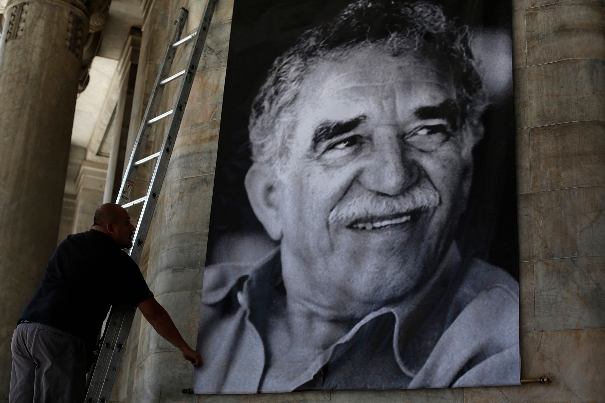Worker arranges a banner with the picture of late Colombian Nobel Prize laureate Garcia Marquez at the Bellas Artes palace in Mexico City