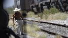 Emiliano walks along the train tracks and outside a train carriage he calls home in Cadereyta on the outskirts of Monterrey August 7, 2012. Emiliano, his eight other family members and their pets have been living in the abandoned carriage next to a train track for the last 15 years. Emiliano and his wife moved from Tamaulipas to Cadereyta after one of their sons was killed on the street by a stray bullet. The family moved into the carriage, which was empty after having been occupied by a vagabond, after living for the first five years in a rented room after arriving in Cadereyta. Picture taken August 7, 2012. REUTERS/Daniel Becerril (MEXICO - Tags: SOCIETY) Published: Srp. 11, 2012, 2:53 dop.