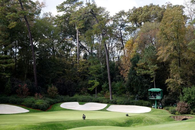 Golf - The Masters - Augusta National Golf Club - Augusta, Georgia, U.S. - November 12, 2020 Tiger Woods of the U.S. lines up his putt on the 13th green during the first