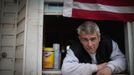 Patrick Zoda, a former New York City Fire Department Fire Fighter, poses for a photograph in the front window of his house in Midland Beach, Staten Island November 15, 2012. Zoda, 46, tried to ride out Hurricane Sandy but as waters quickly rose around his one-story home he was forced to escape by wading through neck-deep water to safety. Zoda who plans to rebuild his home said, "It's just like after 9/11... we support each other and this is my home, I'm not going anywhere." Picture taken November 15, 2012. REUTERS/Mike Segar (UNITED STATES - Tags: DISASTER ENVIRONMENT) ATTENTION EDITORS PICTURE 03 OF 19 FOR PACKAGE 'SURVIVING SANDY' SEARCH 'SEGAR SANDY' FOR ALL PICTURES Published: Lis. 20, 2012, 3:30 odp.