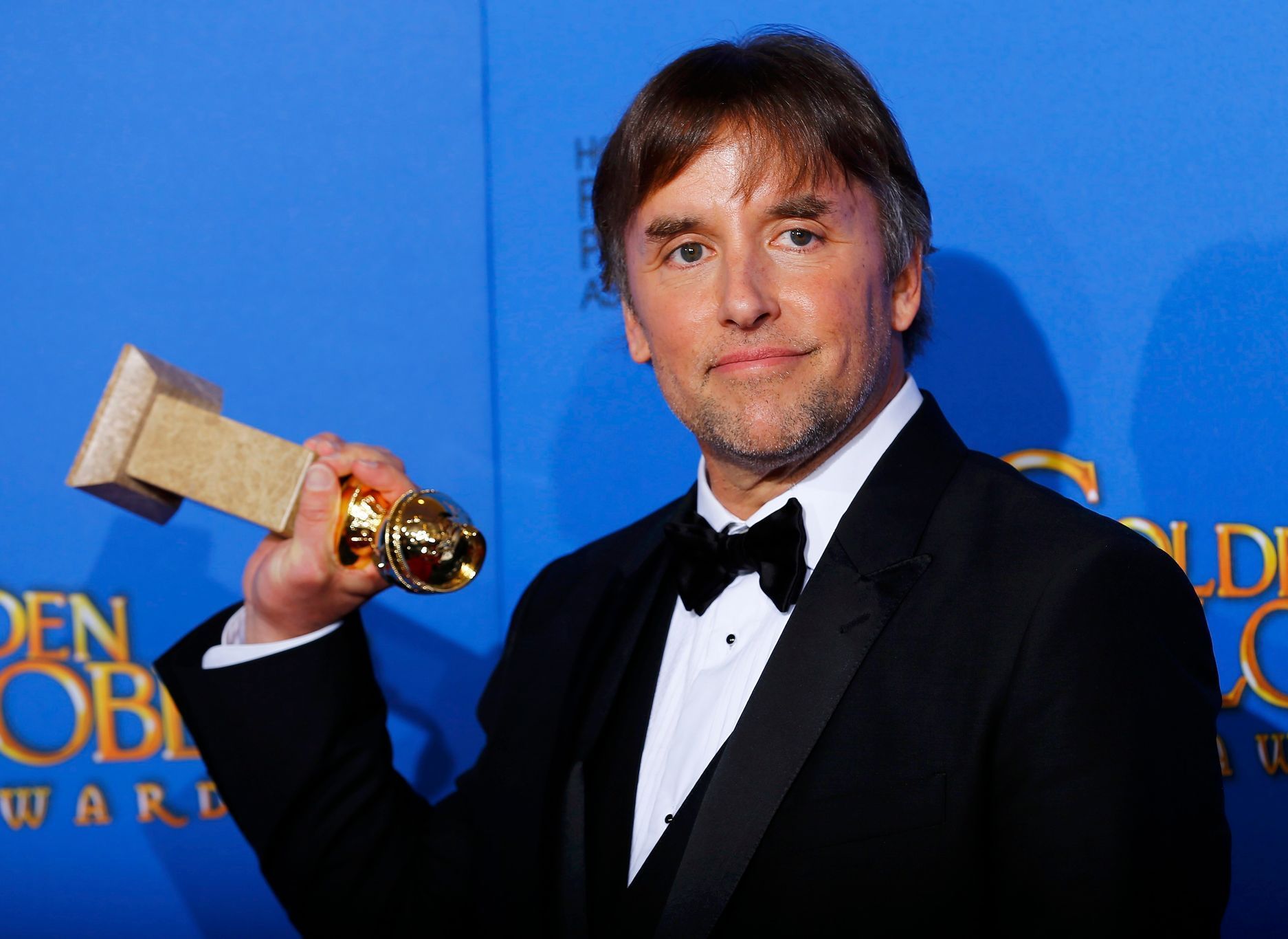 Richard Linklater poses with his award during the 72nd Golden Globe Awards in Beverly Hills