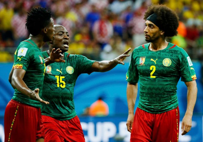 Cameroon's Achille Weboc (C) tries to separate teammates Benjamin Moukandjo (L) and Benoit Assou-Ekotto as they argue during their 2014 World Cup Group A .