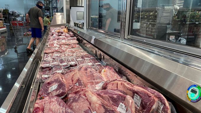Muž stojí u zásob vepřového masa na skladě v americkém státě Texas. Snímek pochází z doby pandemie koronaviru.