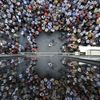 People are reflected on a building as they take part in a pro-EU demonstration in Iraklio on the island of Crete