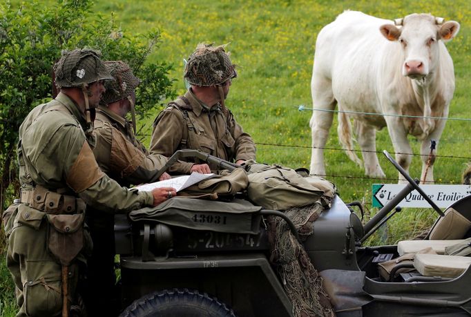 Few days before the 75th anniversary of the allied landings on D-Day, history enthusiasts read a map on a vintage jeep during a re-enactment of D-Day landings