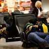 Passengers rest while waiting for their flights at Fraport airport in Frankfurt
