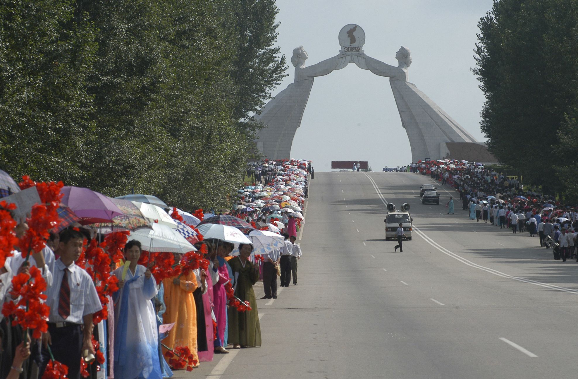 Lidé se účastní oslav Dne národního osvobození poblíž Oblouku znovusjednocení ve městě Pchjongjang v Severní Koreji 14. srpna 2005.