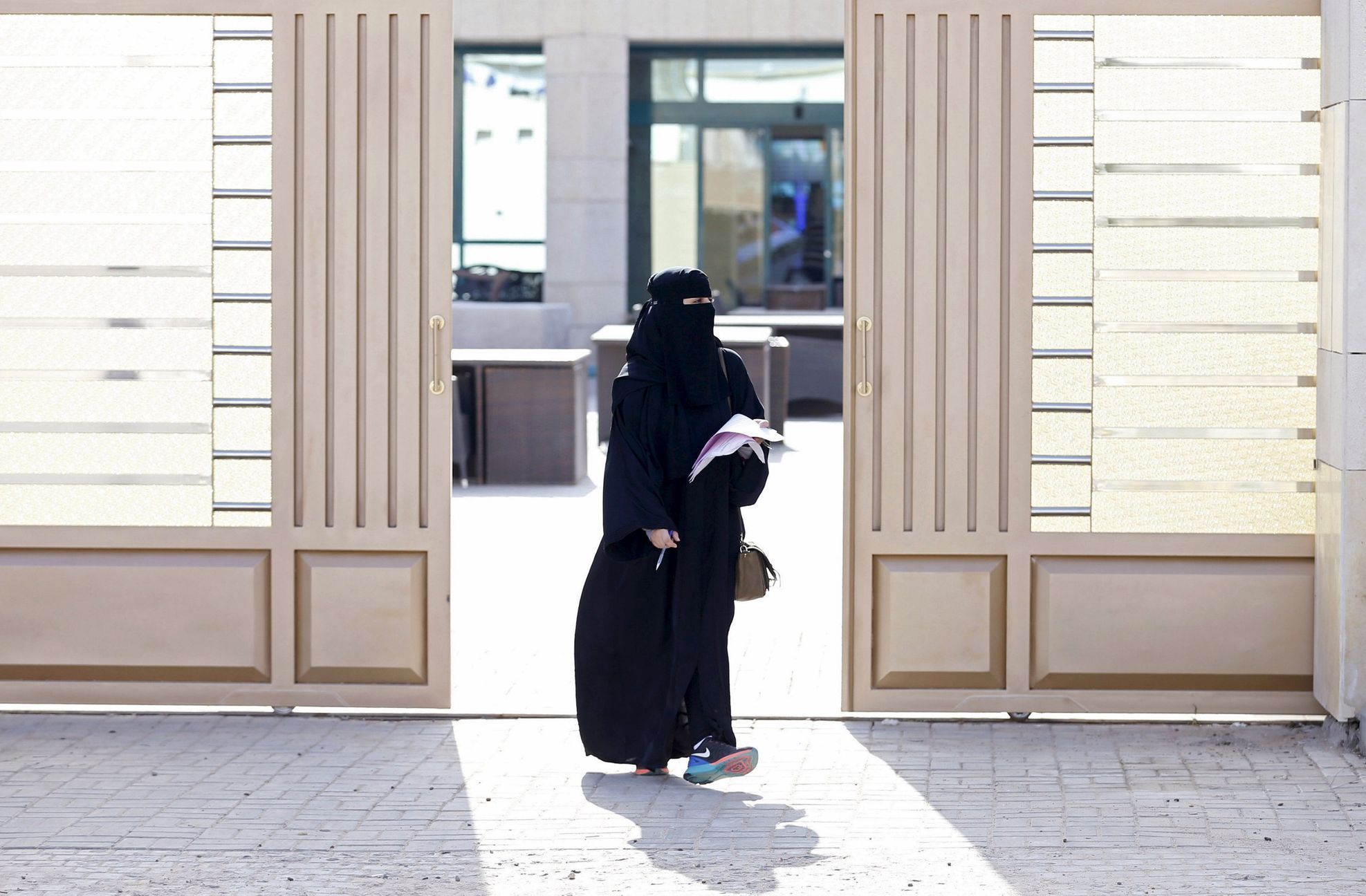 Woman leaves a polling station after casting her vote during municipal elections, in Riyadh, Saudi Arabia