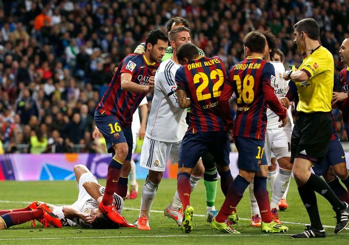 Barcelona's Busquets steps on Real Madrid's Pepe after a Messi goal against Real Madrid during La Liga's second 'Clasico' soccer match of the season in Madrid