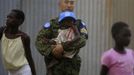 United Nations peacekeeping engineer from Japanese GSDF carries child inside CCC Centre for girls in Juba capital of South Sudan