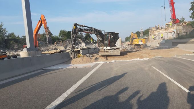 Demolice mostu na dálnici D11 nabírá už druhý den zpoždění. Na místě dál pokračují odklízecí práce.