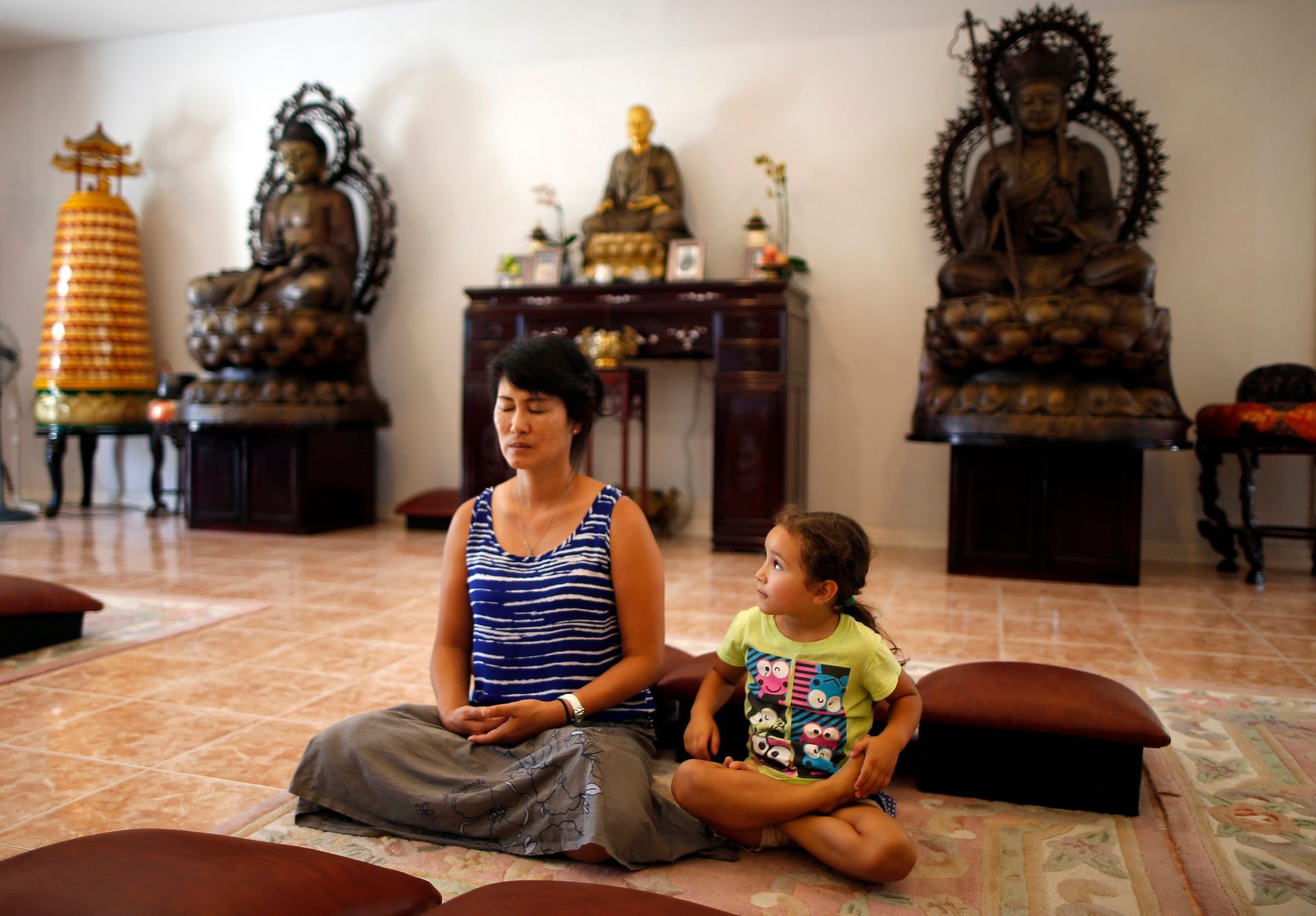 Sarah Kim meditates with Sabina Mayorga at Lu Mountain Buddhist Temple in Rosemead