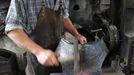 Blacksmith Georg Schmidberger works on a harness for the Vatican Swiss Guard at his workshop in Molln, Upper Austria June 12, 2012. Blacksmith brothers Johann, 29, and Georg, 28, produce made-to-order handmade harnesses for the Vatican, which take 120 hours of handiwork per piece and hardly differs from the 500-year-old originals. The brothers carry on the tradition of the blacksmith trade in the fifth generation of their family. REUTERS/Lisi Niesner (AUSTRIA - Tags: SOCIETY MILITARY) Published: Čer. 12, 2012, 9:50 odp.