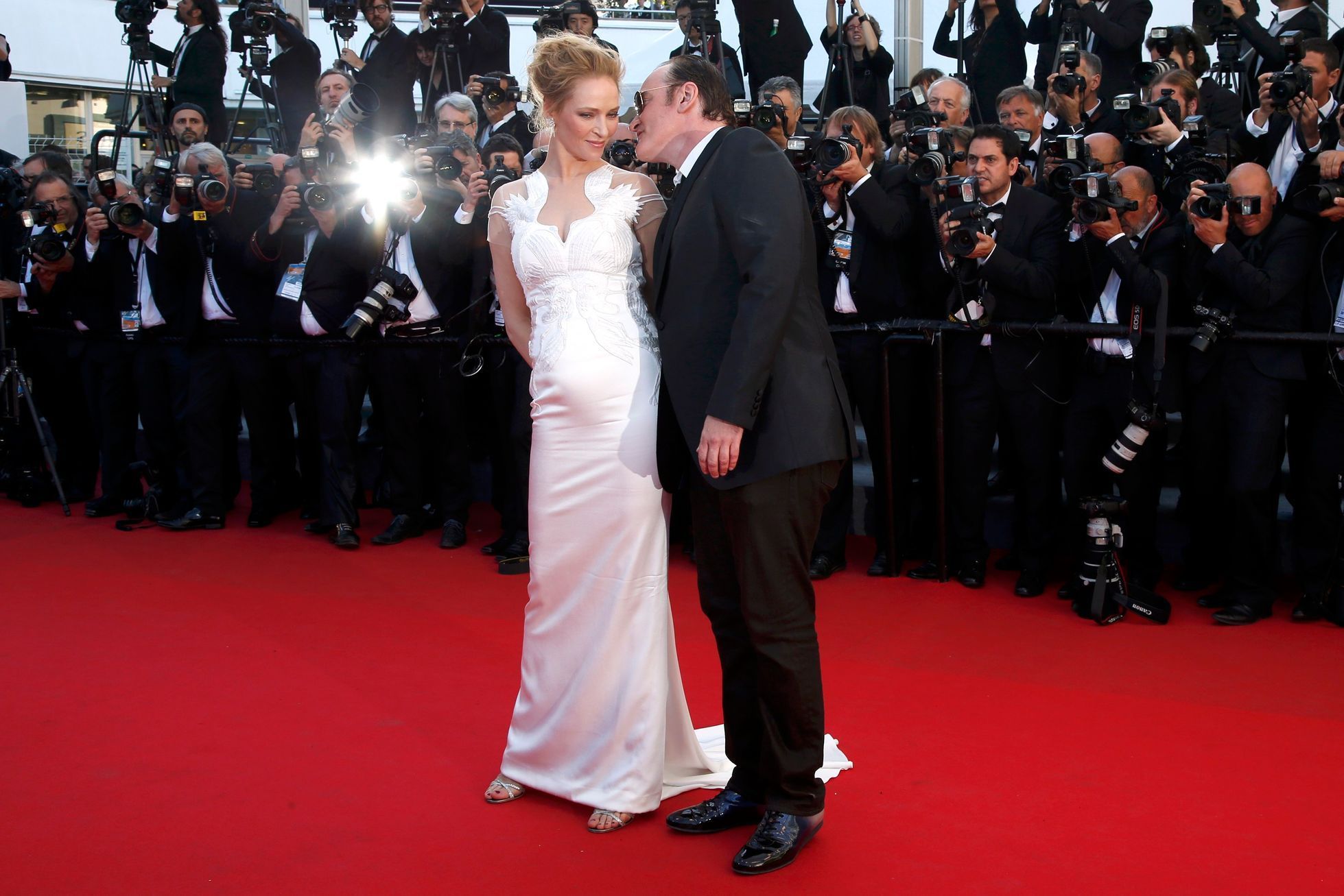 Director Quentin Tarantino and actress Uma Thurman pose on the red carpet as they arrive at the closing ceremony of the 67th Cannes Film Festival