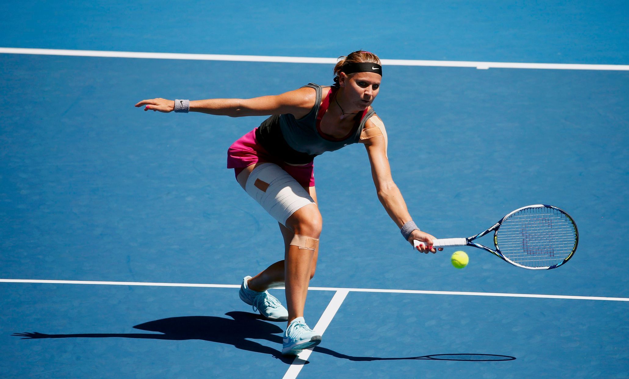 Lucie Safarova of the Czech Republic hits a return to Li Na of China during their women's singles match at the Australian Open 2014 tennis tournament in Melbourne