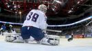 France's goaltender Cristobal Huet (C) concedes a goal during their men's ice hockey World Championship group A game against Italy at Chizhovka Arena in Minsk May 11, 201