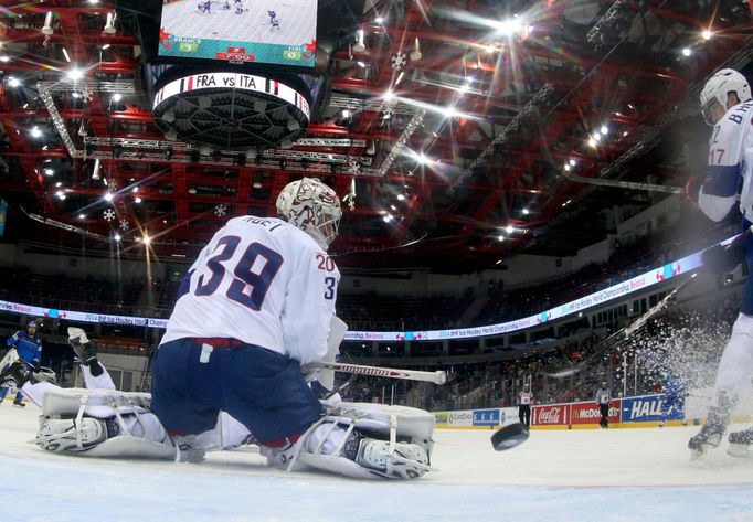 France's goaltender Cristobal Huet (C) concedes a goal during their men's ice hockey World Championship group A game against Italy at Chizhovka Arena in Minsk May 11, 201