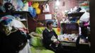 Xiao Cao, a 57-year-old gay man, watches television with his cat in his eight-square-metre apartment in Shanghai April 6, 2012. China's gay community has long been on the edges of society but it is gradually becoming more accepted. Cao, who is an unemployed drag queen, is one whose life lifts the curtain on a less romanticised view of Chinese homosexuals. Living in an eight-square-metre apartment behind a public toilet and with a monthly income of 500 yuan ($79) from social insurance, he passes his days dancing in public and spending time with friends at gay clubs. Picture taken April 6, 2012. REUTERS/Aly Song (CHINA - Tags: SOCIETY) CHINA OUT. NO COMMERCIAL OR EDITORIAL SALES IN CHINA. ATTENTION EDITORS PICTURE 02 OF 28 OF PACKAGE 'GAY AND OUT IN CHINA' TO FIND ALL IMAGES SEARCH 'GAY OUT CHINA' Published: Čer. 1, 2012, 12:33 dop.