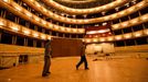 Workers carry a part of the dance floor in the opera house in Vienna