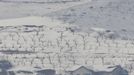 North Korean children (bottom R) make a snowman in the village of Gijungdong, North Korea, in this picture taken from a South Korean observation post, just south of the demilitarized zone separating the two Koreas, in Paju, north of Seoul, February 6, 2013. New York under missile attack is a remote dream for impoverished North Korea, yet that is precisely what the latest propaganda video from the isolated state shows as it readies a third nuclear test. North Korea has trailed plans to carry out a third nuclear test, which experts believe is imminent. REUTERS/Lee Jae-Won (SOUTH KOREA - Tags: MILITARY POLITICS ENERGY CONFLICT SOCIETY) Published: Úno. 6, 2013, 8:07 dop.