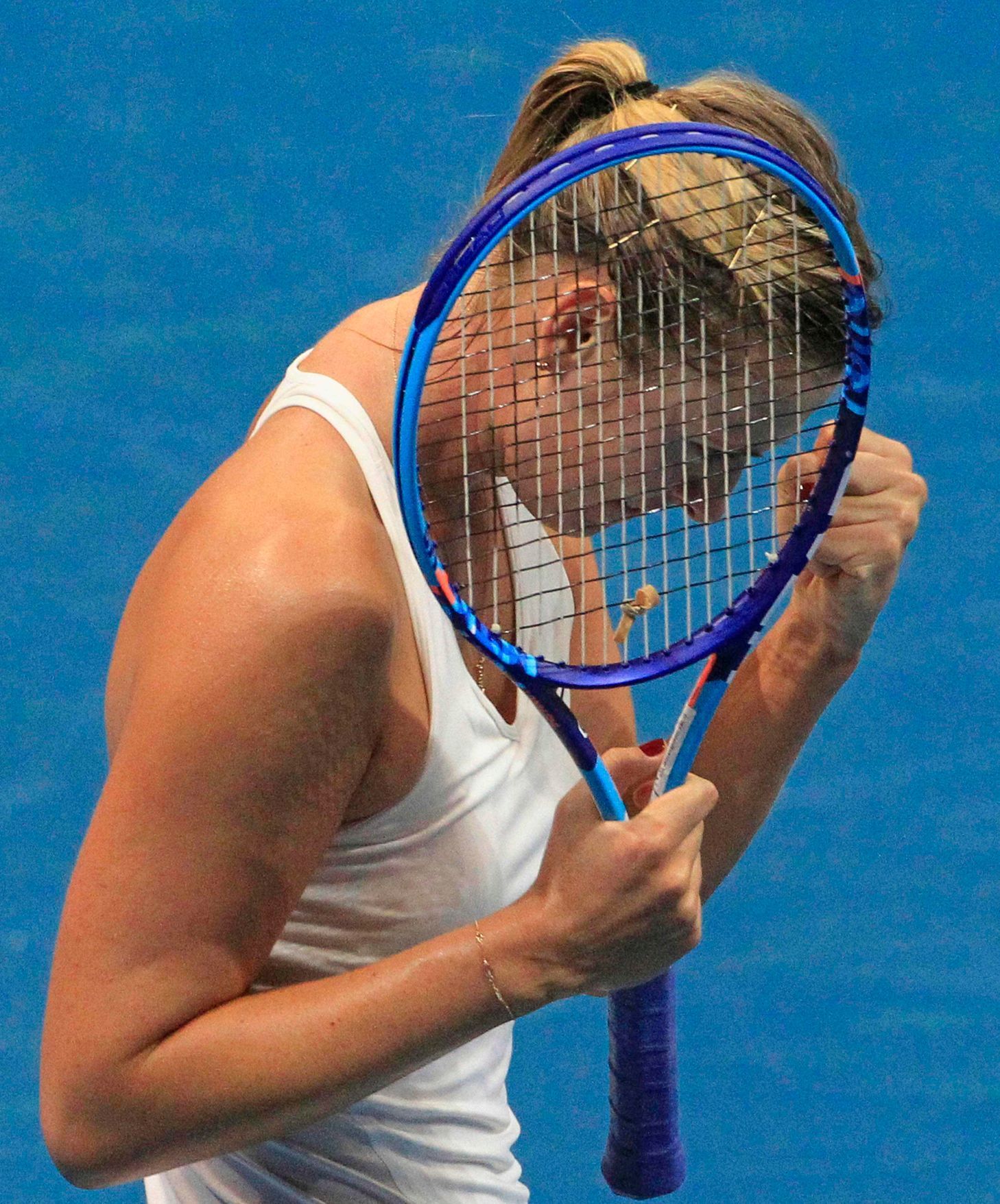 Sharapova of the Manila Mavericks team gestures after beating Mladenovic of the UAE Royals team during their women's singles tennis match at the IPTL competition in Manila
