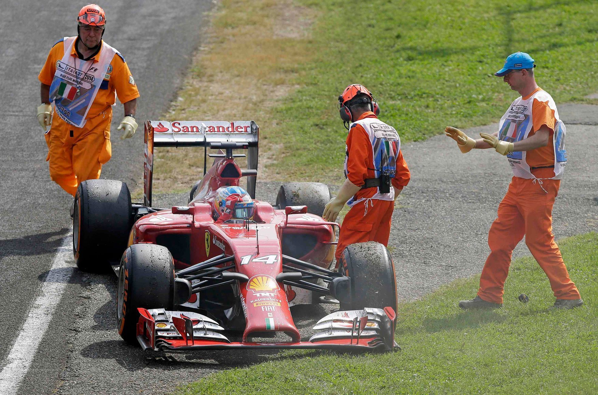 Ferrari Formula One driver Alonso of Spain stops the race as his car breaks down during the Italian F1 Grand Prix in Monza