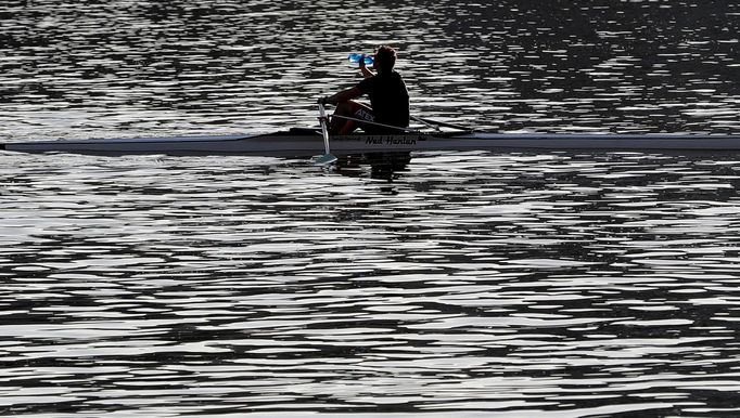 A man drinks a water as he rows a boat on the Vltava river in Prague, Czech Republic March 21, 2019.  REUTERS/David W Cerny